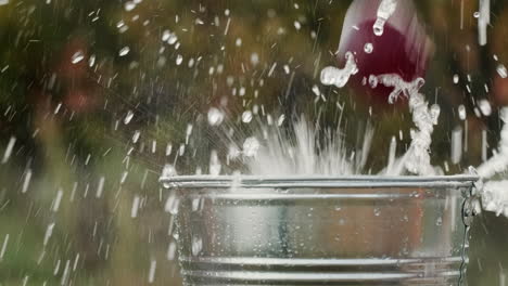 various ripe fruits fall into a bucket of water