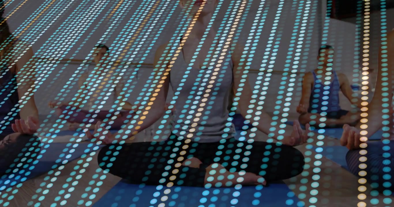 Dotted overlay appearing, woman in gray tank rising to seated on blue mat, yoga class meditating