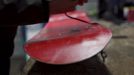 Close-up-shot-of-hot-wax-dripping-on-snowboard