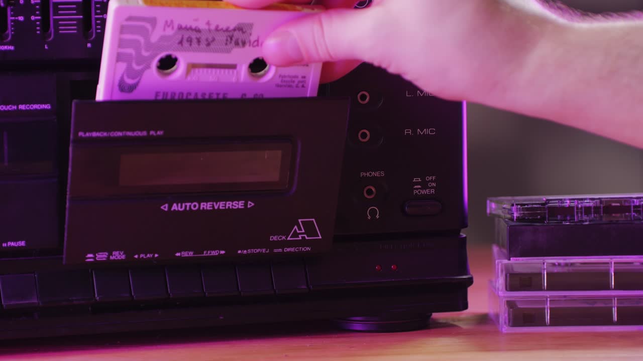 Retro radio tape recorder, audio cassette close-up. Listening to music, old radio boom box player, macro of vintage music listening.