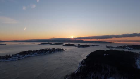 Golden-Hour-Sunset-On-Horizon-With-Sillhouute-Of-Islands-Near-Bjorvika,-Oslo