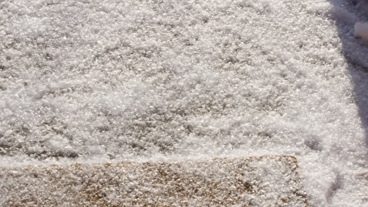 Fresh white snowflakes falling on front doorstep, slow motion handheld.