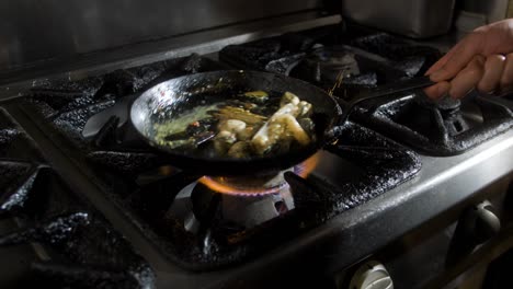 Mussels-tossed-around-in-a-cooking-pan