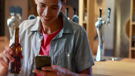 Smiling-man-taking-a-picture-of-food-on-his-mobile-phone-4k