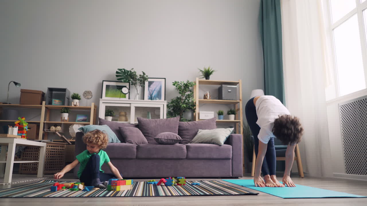 Mother and child practicing yoga at home