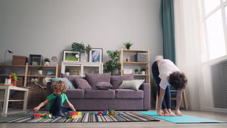 mother and child practicing yoga at home
