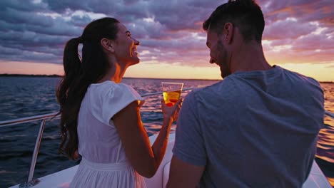 couple enjoying cocktails at sunset on a boat