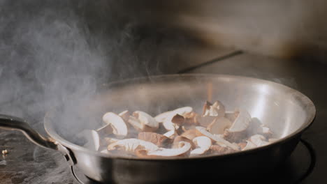 mushrooms being sautéed in a hot pan