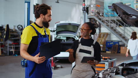 repair shop workers fixing car together