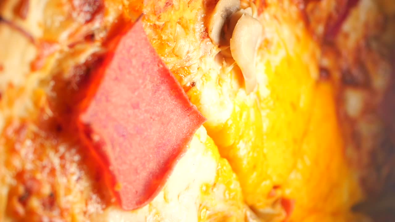 Pizza with salami being cut