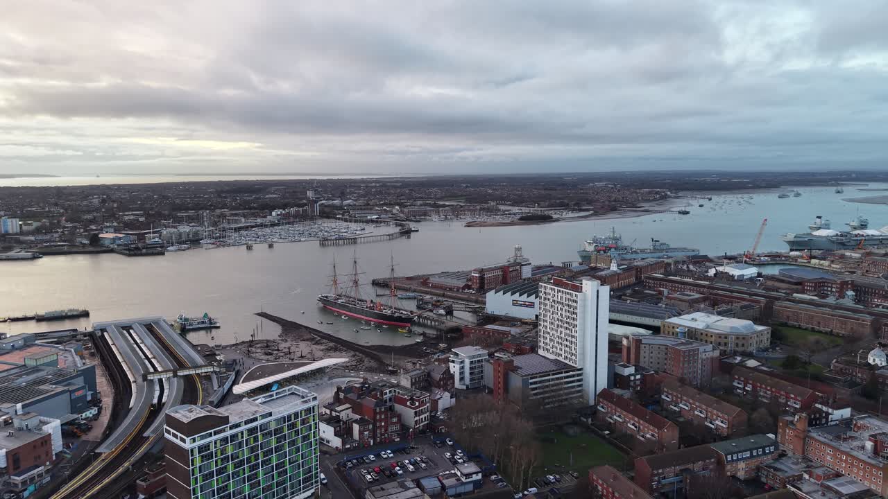 Portsmouth UK Waterfront at dusk, pull back drone aerial reverse reveal