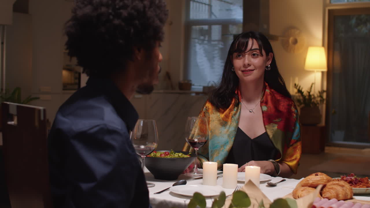 Man Giving Flowers to His Wife during Celebration at Table