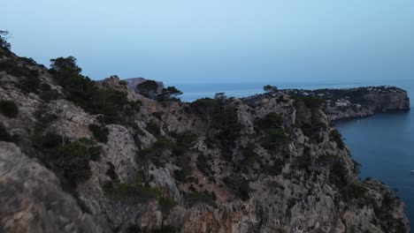 Fpv-Drone-view-of-settlements-around-Cala-d'egos-beach,-Spain