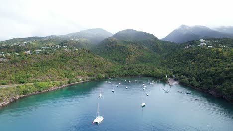 scenic landscape of anse a la barque bay with boats in vieux-habitants, guadeloupe - aerial drone shot