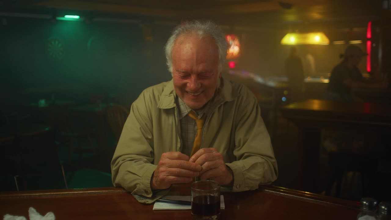 Man laughs and gets into a coughing fit at a bar