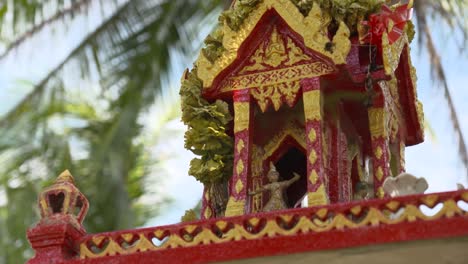 the beautiful red and gold thai spirit house, a symbol of spirituality - close up