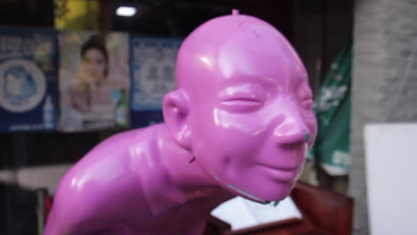 pink sculpture head in an urban setting