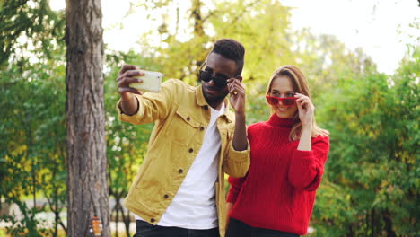 couple taking a selfie in an autumn park