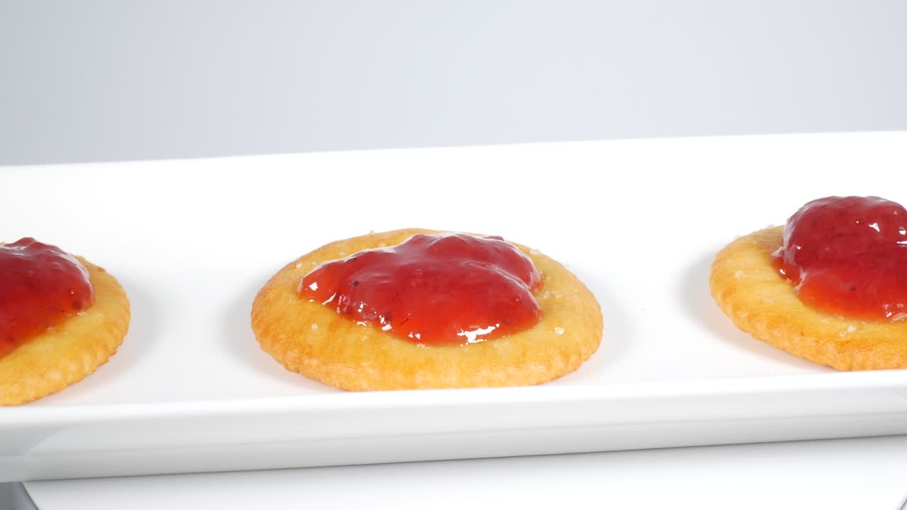 Round crackers with strawberry jam