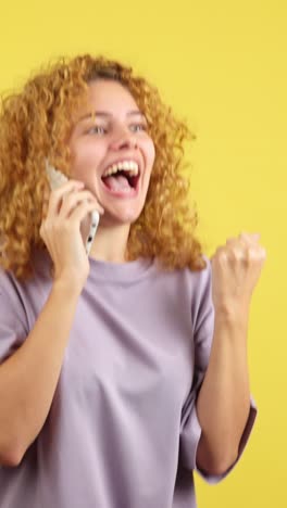 excited woman celebrating good news on a phone call