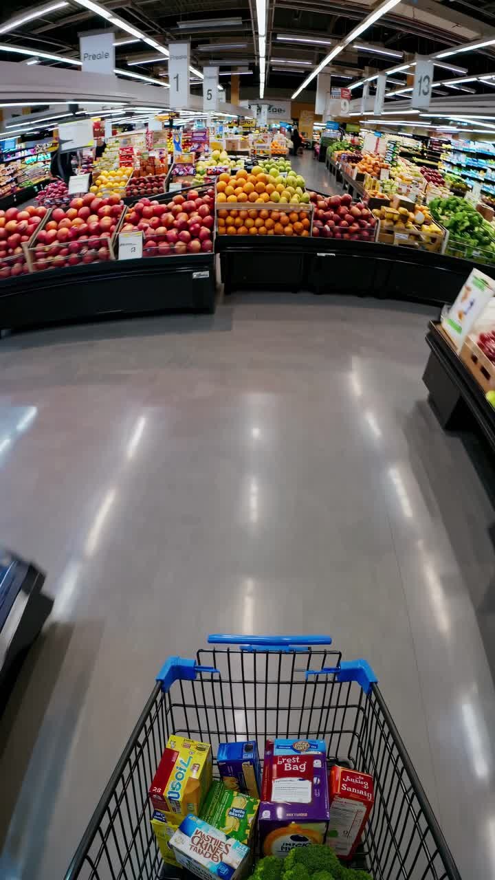 A dynamic, wide-angle video shot of a supermarket aisle, showcasing colorful, blurred motion