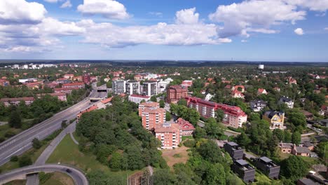 Lidingö-in-Stockholm-with-drone-views-of-the-iconic-bridge,-flowing-river,-and-charming-residential-areas,-real-estate,-and-urban-projects,-a-harmonious-blend-of-nature-and-city-life