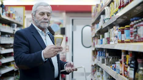 mature man shopping in supermarket