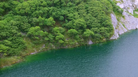 The-old-closed-rock-quarry-a-natural-tourist-attraction-with-a-large-blue-pond-is-an-interesting-point-in-Thailand