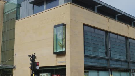 tan stone building with metal roof in modern architecture style