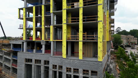 Aerial ascending footage of building under construction