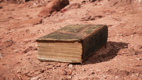 old book in red rock desert