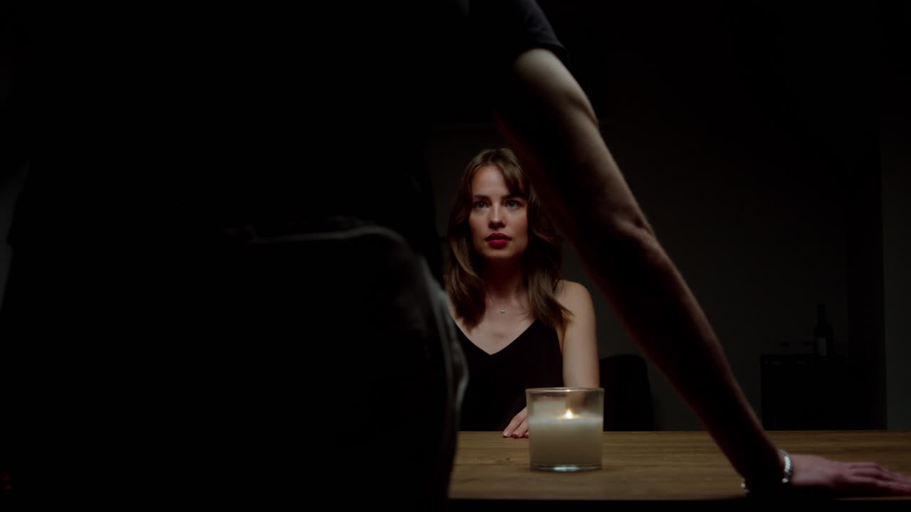 A Woman Recoils in Fear as a Man Looms Over the Table, Shouting at Her - Close Up