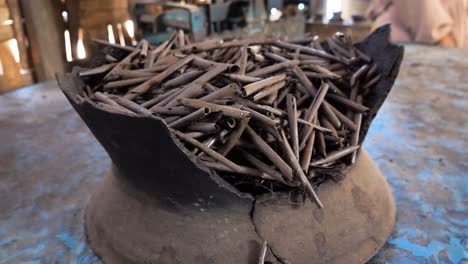 slow motion establishing shot of ampo sticks made from smoked soil in indonesia