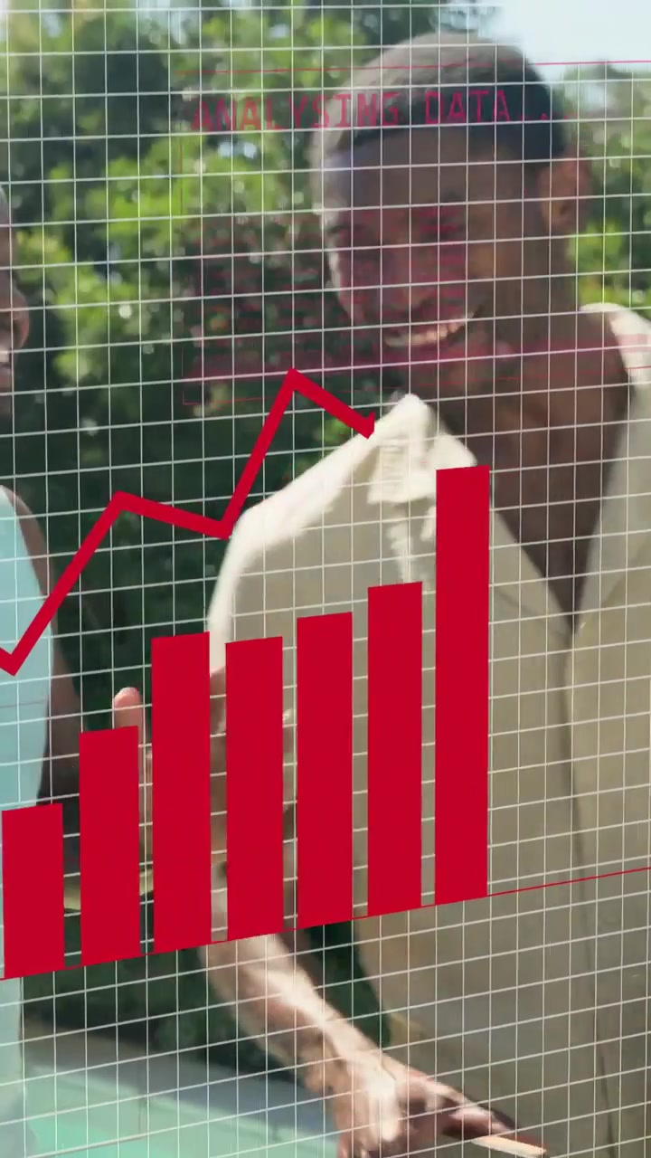 Vertical video: Man holding phone, woman raising hand causing red business charts overlaying growth
