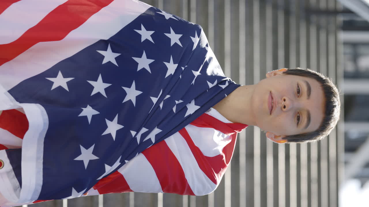 Person draped in American flag on stairs