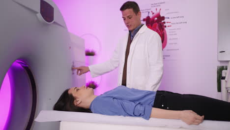 doctor supervising patient during ct scan procedure