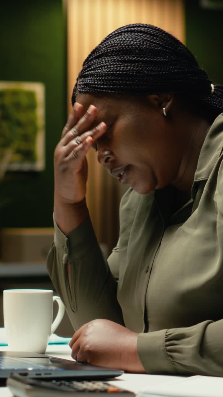 Vertical Video Fatigued entrepreneur sighing and struggling to stay awake late at night