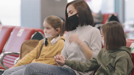 woman with kids in departure lounge