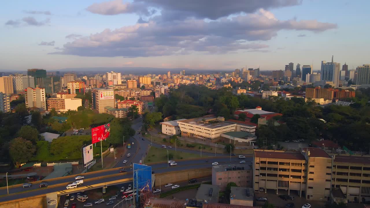 Aerial view of Nairobi, Kenya during sunset. Traffic flows through the city center as the warm light casts long shadows.