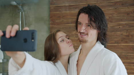 couple taking selfies in a bathroom