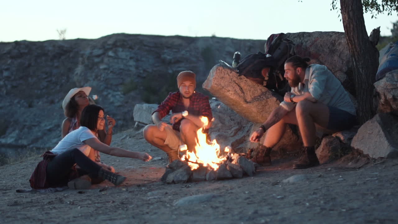 Friends roasting marshmallows over a campfire