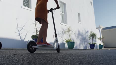 two mixed race women riding electric scooter