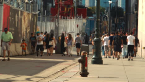 defocused pedestrians walk along street at world trade centre