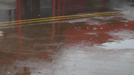 Rain-falling-on-a-pavement-sidewalk