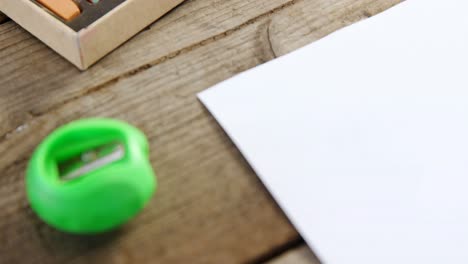 Watercolor-paint-box-and-sharpener-on-wooden-table