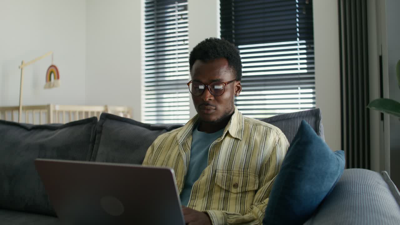 Man Working on Laptop at Home