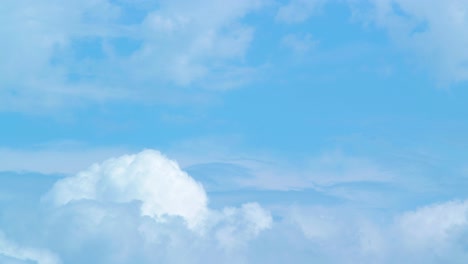 Time-lapse-of-beautiful-white-fast-moving-fluffy-clouds-and-sky-in-sunny-day,-medium-shot