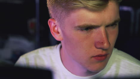 Male-Teenage-Hacker-Sitting-In-Front-Of-Computer-Screens-Bypassing-Cyber-Security