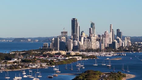drone captures panoramic view of gold coast skyline and waterways during sunset, highlighting urban landscape and vibrant colors