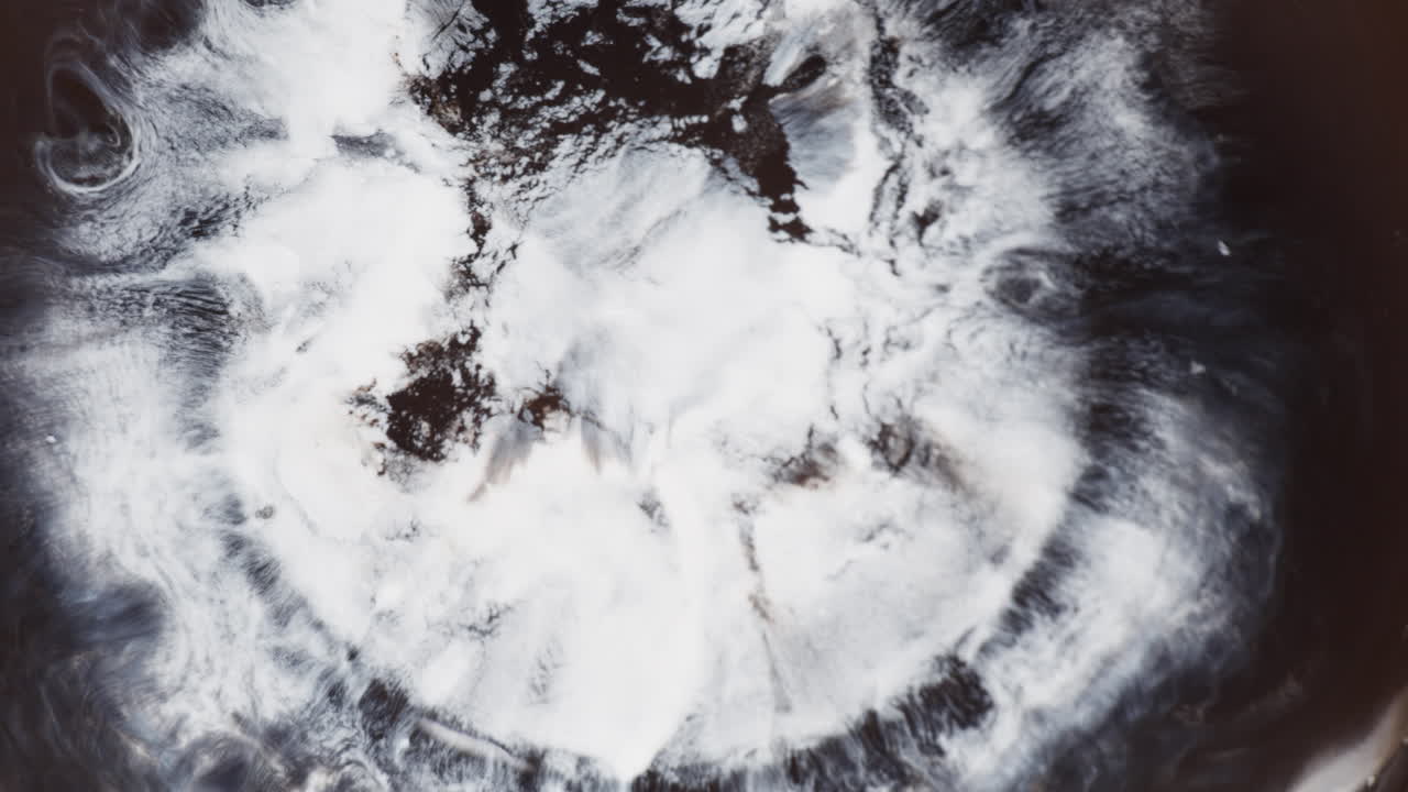 White Color Drop On Black Ink. Abstract Background